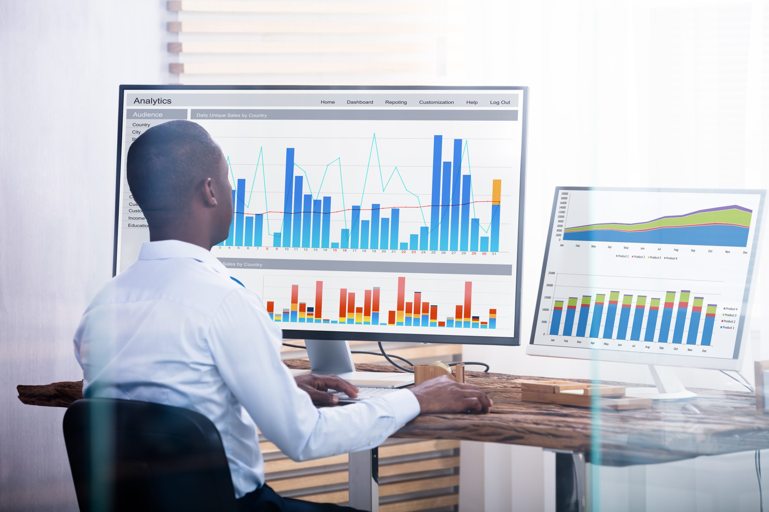 Rear,View,Of,Young,Businessman,Looking,At,Graph,On,The